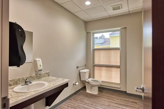 Accessible restroom with grab bar and granite vanity at Allergy & Asthma Physicians of Commerce Township