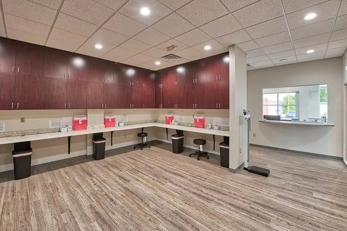 Allergy lab workstations with stools along wood cabinets at Allergy & Asthma Physicians of Commerce Township