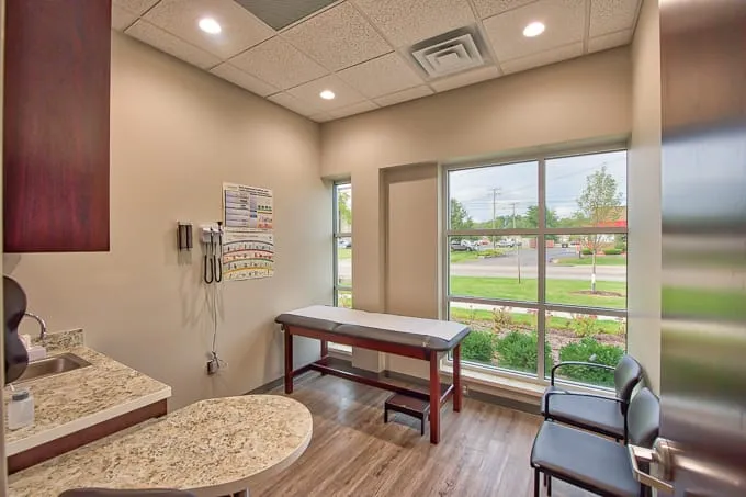 Exam room with exam table and a large window overlooking the street at Allergy & Asthma Physicians of Commerce Township