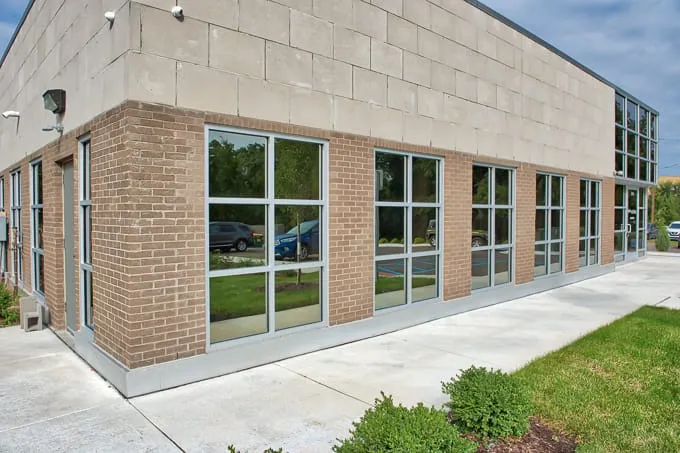 Brick and stone building corner with large windows at Allergy & Asthma Physicians of Commerce Township in Commerce Township