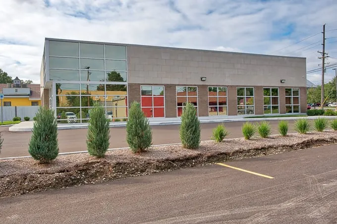 Side of the building with evergreen landscaping at Allergy & Asthma Physicians of Commerce Township in Commerce Township