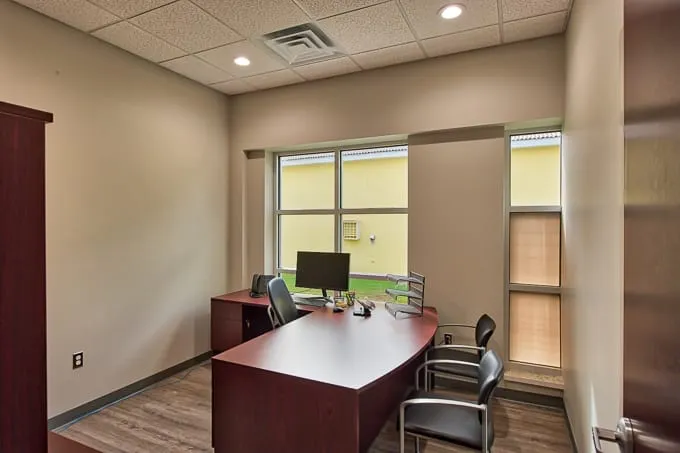 Private office with desk, computer and guest chairs at Allergy & Asthma Physicians of Commerce Township